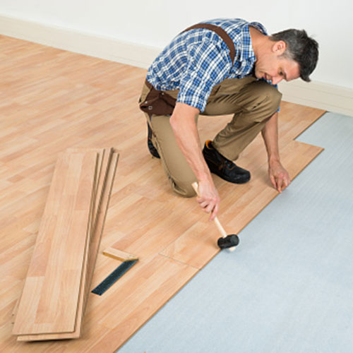 Contractors install flooring